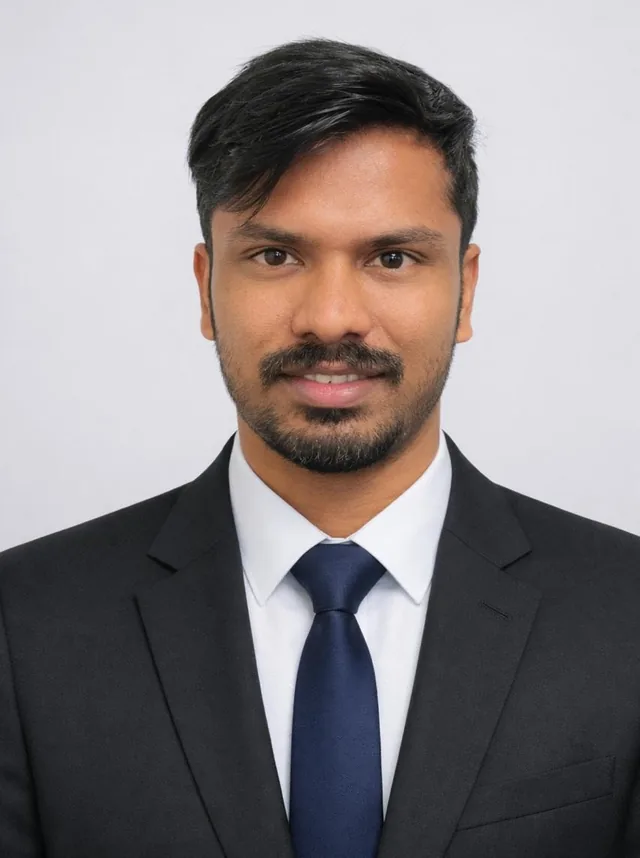 Portrait of Midhun Rajeev in a dark suit